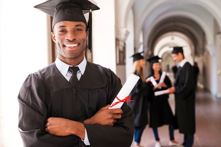 college graduate holding his diploma | Subaru of Utica in Yorkville NY