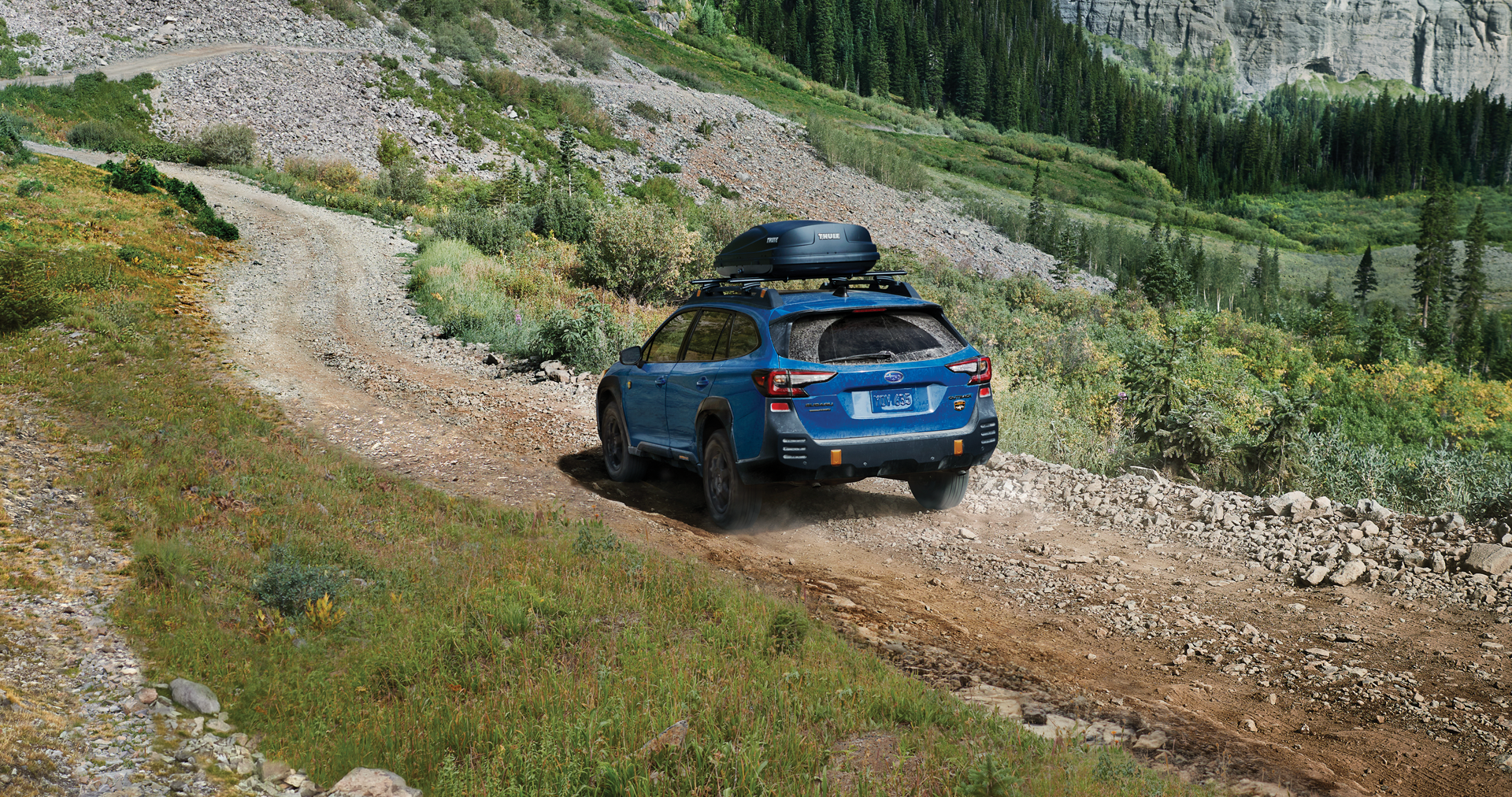 A 2023 Outback Wilderness driving on a trail in the mountains. | Subaru of Utica in Yorkville NY